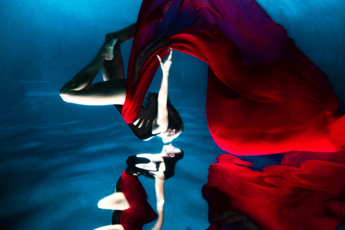 woman-in-black-and-red-dress-wet-swim-show-underwater-modeling