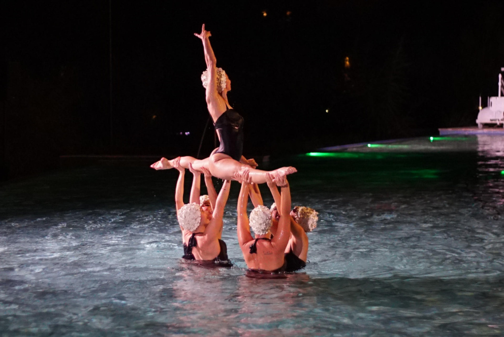 Syncronized swimers splits out of water